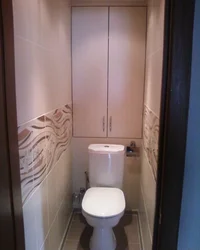 Design Of A Toilet In An Apartment With A Cabinet And Tiles