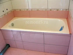 Photo Of The Bathtub Covered With Tiles