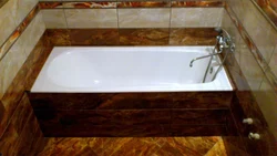 Photo Of The Bathtub Covered With Tiles