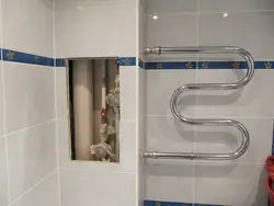 Photo of bathtub tiles and pipes