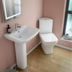 Toilet in the corner of the bath photo