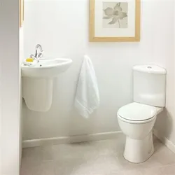 Toilet in the corner of the bath photo