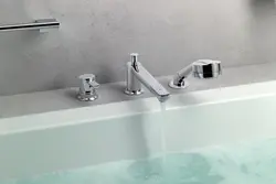 Install faucet on bathtub photo