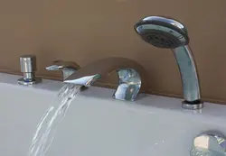 Install faucet on bathtub photo