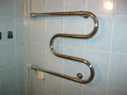 Heated towel rail pipe in the bathroom photo