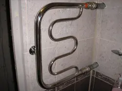 Heated towel rail pipe in the bathroom photo