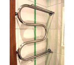 Heated towel rail pipe in the bathroom photo