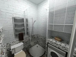 Bathtub with brick panels photo