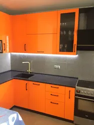 Orange kitchen black countertop photo