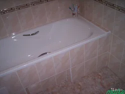 Acrylic bathtub in tiles photo
