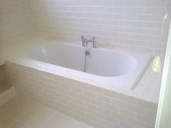 Acrylic bathtub in tiles photo