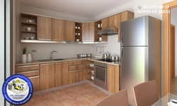 Photo of a kitchen with a refrigerator and a table
