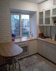 Photo Of A Kitchen With A Refrigerator And A Table