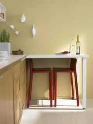 Photo of a small kitchen table against the wall