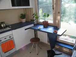 Photo of a small kitchen table against the wall