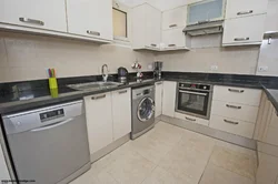 Straight kitchen with dishwasher photo