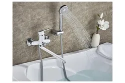 Bathtub and faucets with long photo