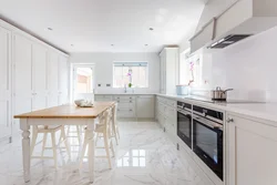 Light tiles in the kitchen interior photo