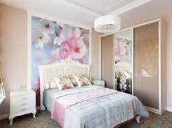 Photo of a bedroom with flowers at the headboard