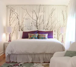 Photo of a bedroom with flowers at the headboard