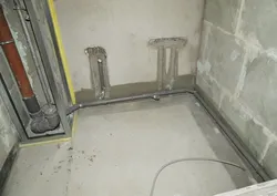 Pipes in the floor in the bathroom photo