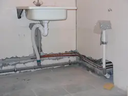 Pipes in the floor in the bathroom photo
