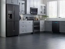 Gray kitchen with black refrigerator photo