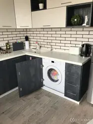 Black washing machine in the kitchen photo