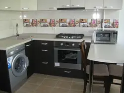 Black washing machine in the kitchen photo