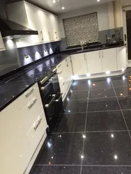 White kitchen on black tiles photo