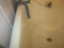 Washing machine draining into bathtub photo