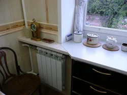 Refrigerator near the radiator in the kitchen photo