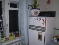 Refrigerator Near The Radiator In The Kitchen Photo