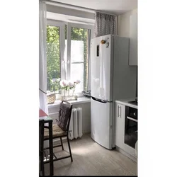 Refrigerator near the radiator in the kitchen photo