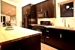 Black and brown kitchens in the interior photo