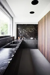 Black marble in the kitchen interior photo