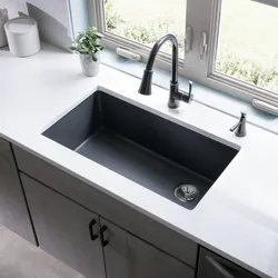 Sink on a light kitchen countertop photo