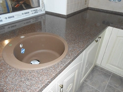 Sink on a light kitchen countertop photo