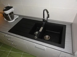 Sink on a light kitchen countertop photo