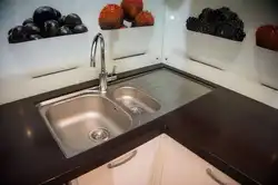 Sink on a light kitchen countertop photo