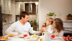 Family At The Table In The Kitchen Photo