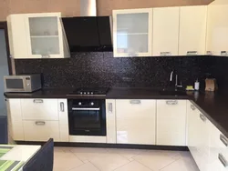 Black Kitchen With Brown Countertop Photo