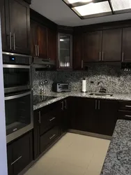 Black Kitchen With Brown Countertop Photo