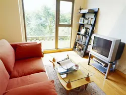 Living room with only a sofa and TV photo