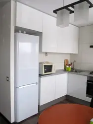 Kitchens on one side with a refrigerator photo