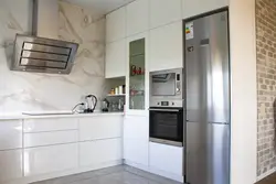 Kitchens on one side with a refrigerator photo