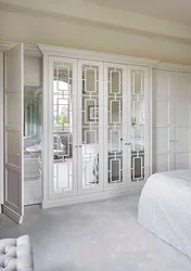White wardrobe with mirror in the bedroom photo