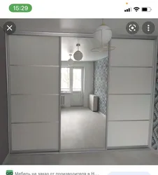 White wardrobe with mirror in the bedroom photo