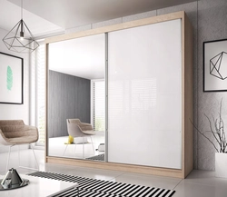 White wardrobe with mirror in the bedroom photo