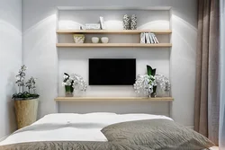 Built-in shelves in the wall in the bedroom photo